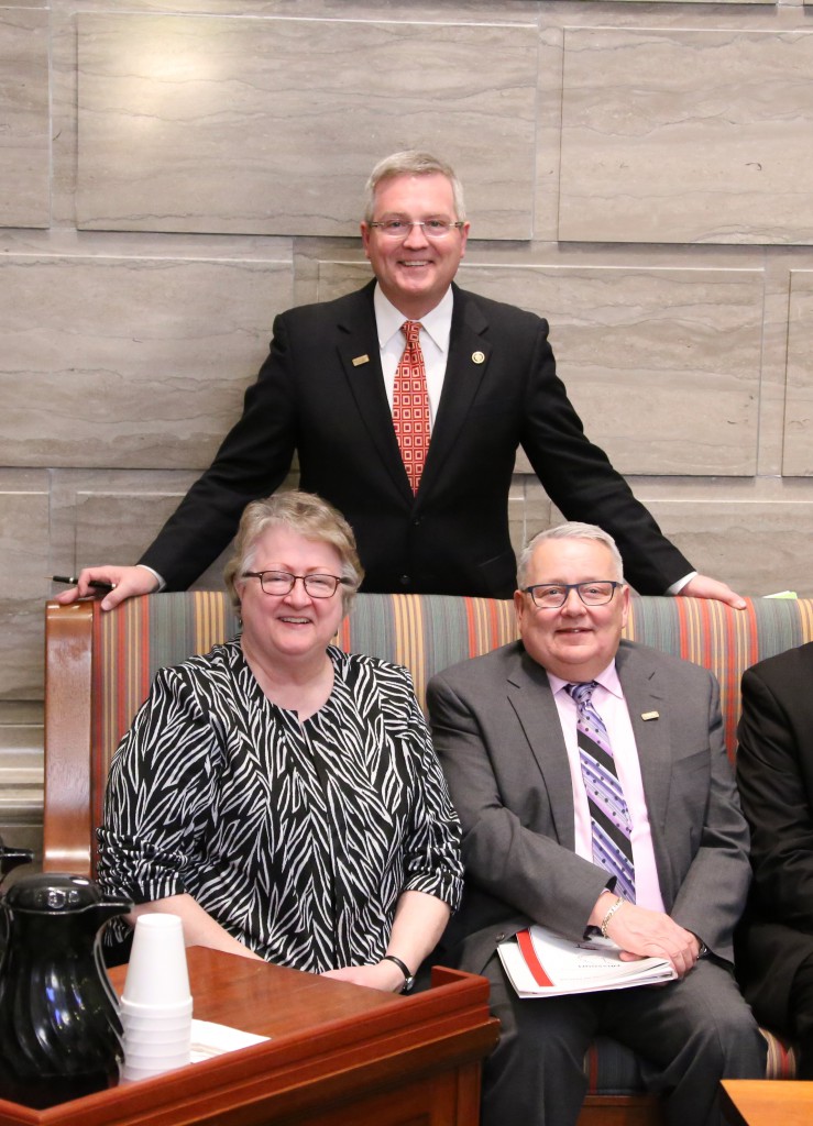 Sen. Pearce stands with Pam Schutt and Larry Isaak of MHEC on the Senate Floor.