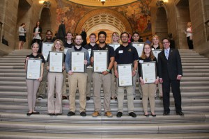Sen. Schaefer presents a group of MU students with resolutions for their excellence in research.