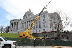 Construction crews are utilizing a crane to remove balustrades along the northwest side of the building.
