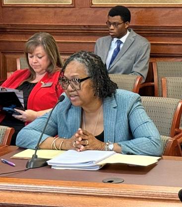 A person sitting at a deskAI-generated content may be incorrect.