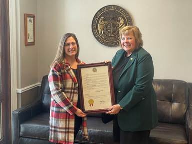 A few women holding a certificateAI-generated content may be incorrect.