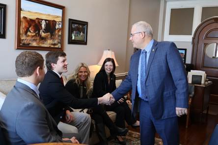 A person shaking hands with a group of peopleAI-generated content may be incorrect.