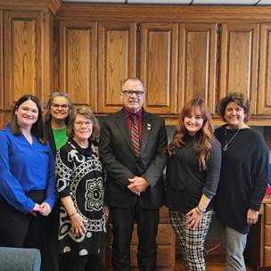 A group of people posing for a photoAI-generated content may be incorrect.