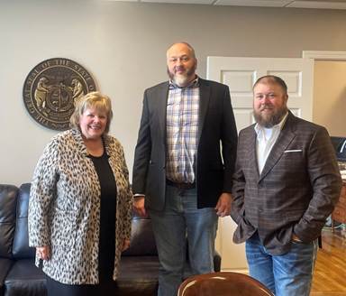 A group of people posing for the cameraAI-generated content may be incorrect.