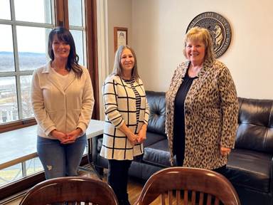 A group of women posing for a pictureAI-generated content may be incorrect.